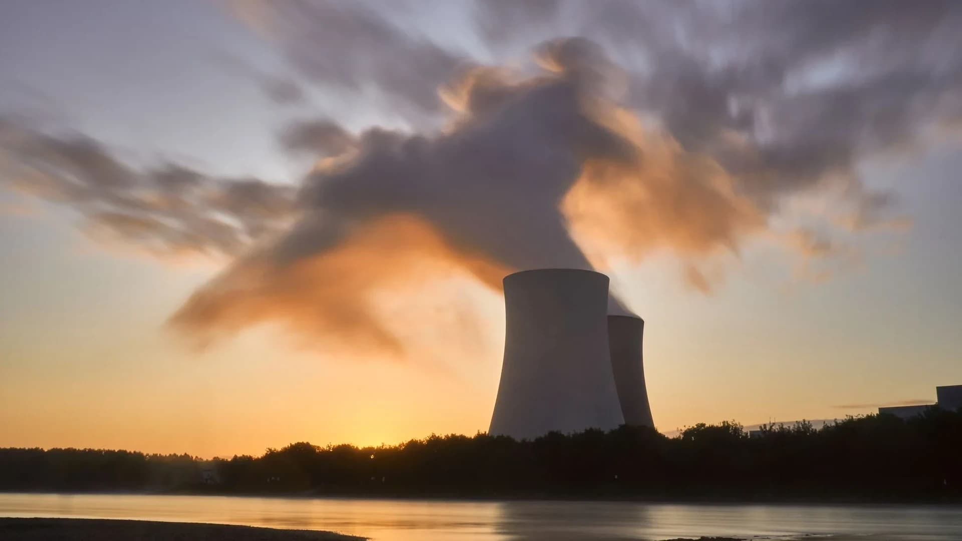 Scenic view of a nuclear power plant with cooling towers emitting steam in Hameln, Germany.