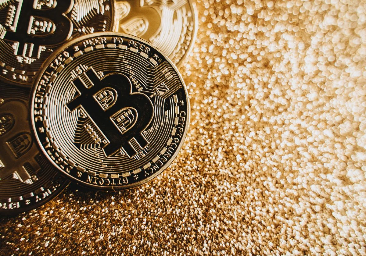 Bitcoin coins on a gold background