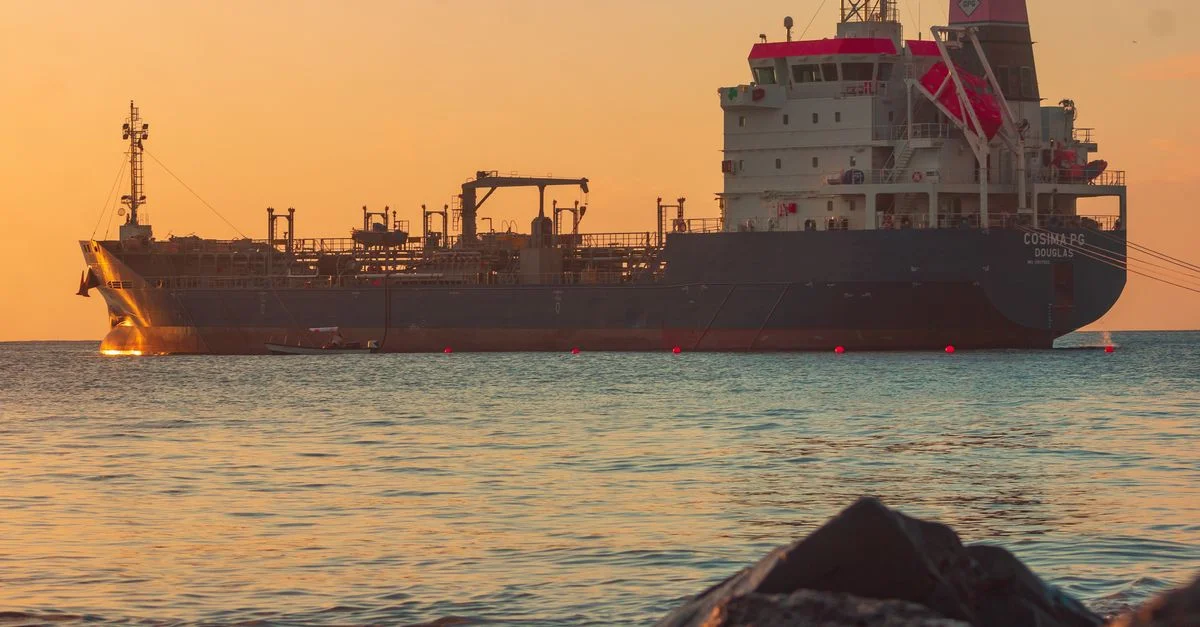 An oil tanker at sea at sunset